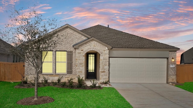 view of front facade with a yard and a garage