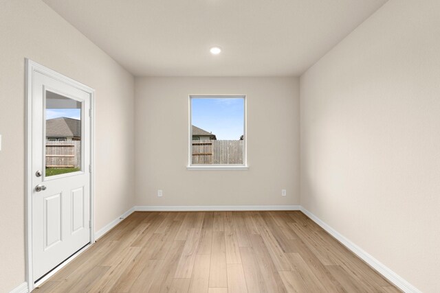 spare room with light hardwood / wood-style flooring