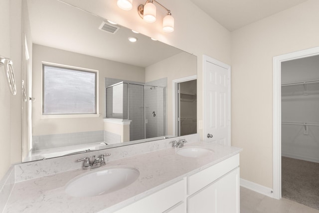 bathroom featuring tile patterned flooring, vanity, and independent shower and bath