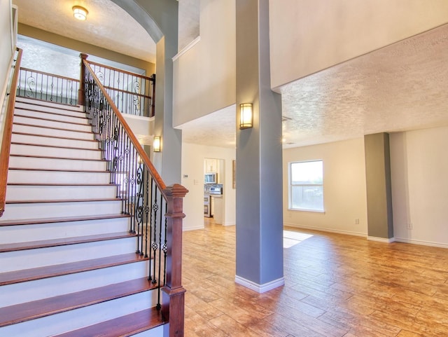 staircase with hardwood / wood-style flooring