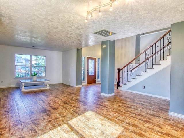 unfurnished living room with hardwood / wood-style floors