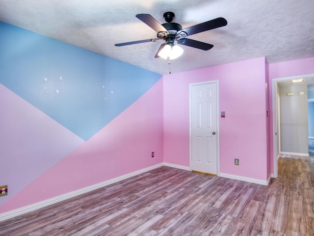 bonus room featuring ceiling fan, light hardwood / wood-style floors, and a textured ceiling