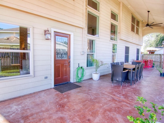 doorway to property with ceiling fan and a patio area