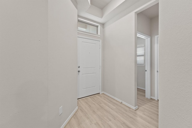 corridor with light hardwood / wood-style floors