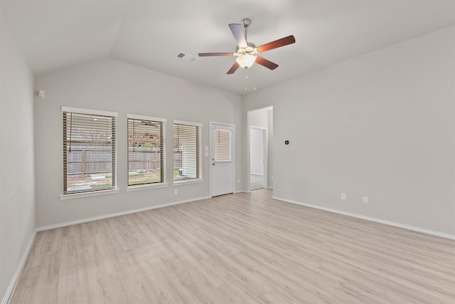 spare room featuring ceiling fan, vaulted ceiling, and light wood-type flooring