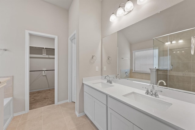 bathroom featuring tile patterned flooring, vanity, and shower with separate bathtub