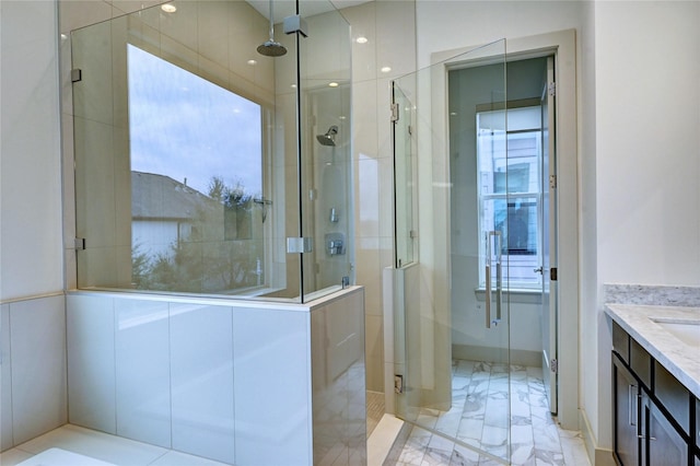 bathroom featuring vanity and an enclosed shower