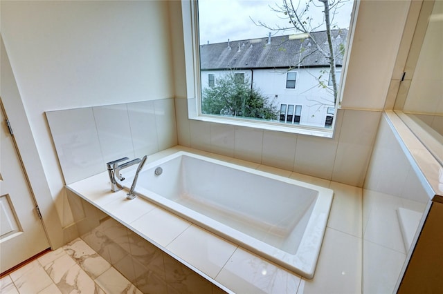 bathroom with a relaxing tiled tub