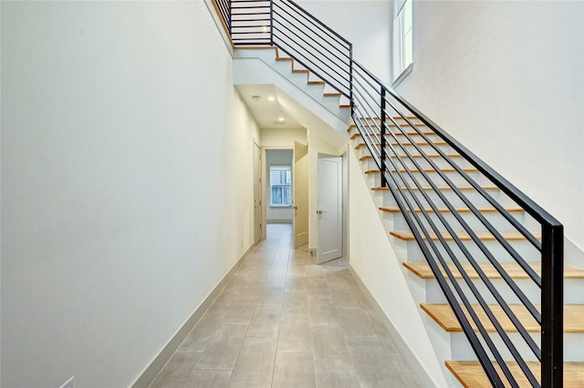 stairs featuring a towering ceiling