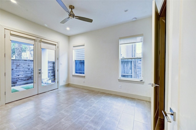 unfurnished room with ceiling fan and french doors