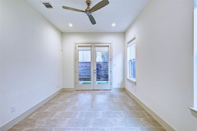 empty room with ceiling fan and french doors