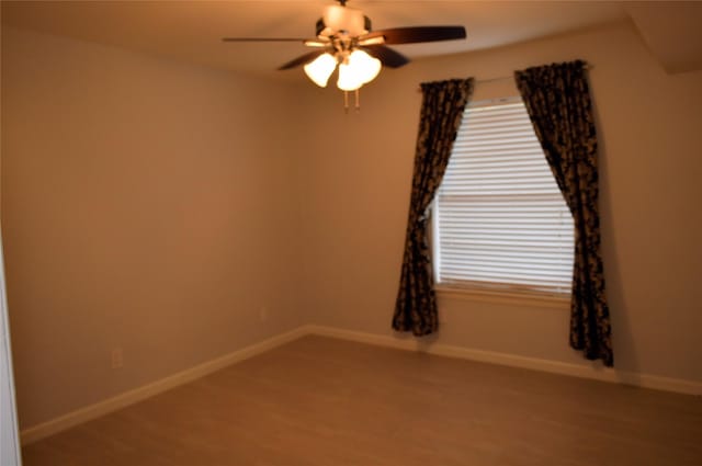 empty room with ceiling fan and hardwood / wood-style flooring