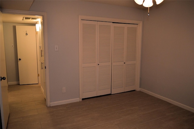 unfurnished bedroom featuring light hardwood / wood-style floors and a closet