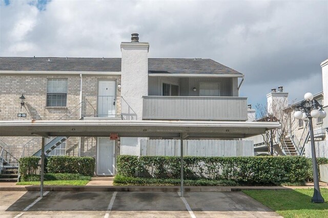 rear view of house with a balcony