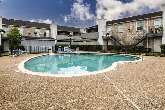 view of swimming pool with a patio