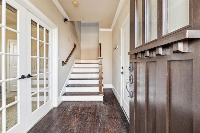 foyer entrance with french doors, dark hardwood / wood-style floors, and ornamental molding