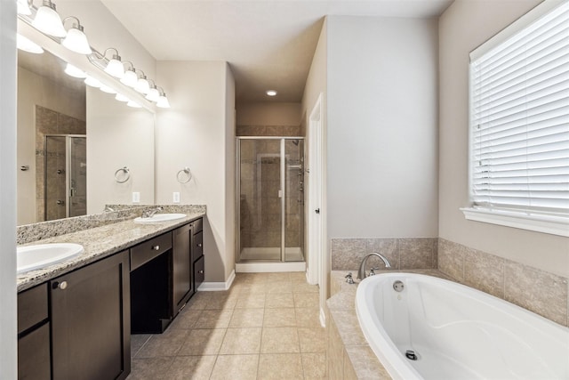 bathroom with plus walk in shower, vanity, and tile patterned flooring