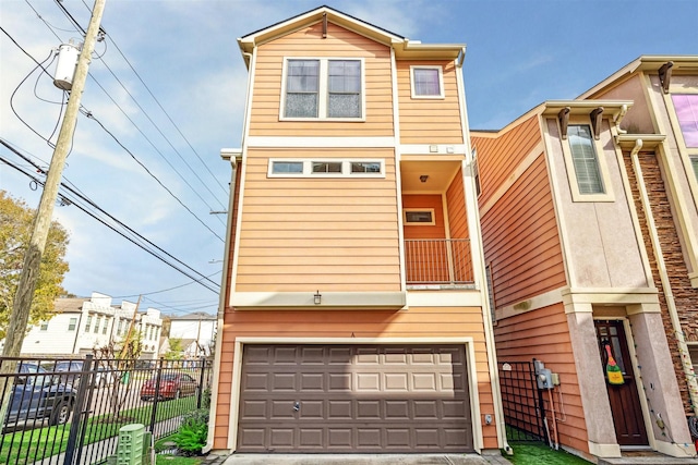 front facade featuring a balcony and a garage