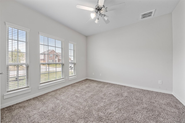 carpeted spare room with ceiling fan