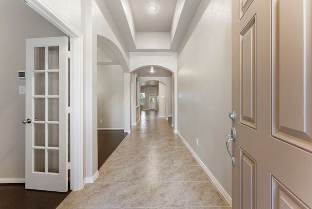 tiled entryway featuring a raised ceiling