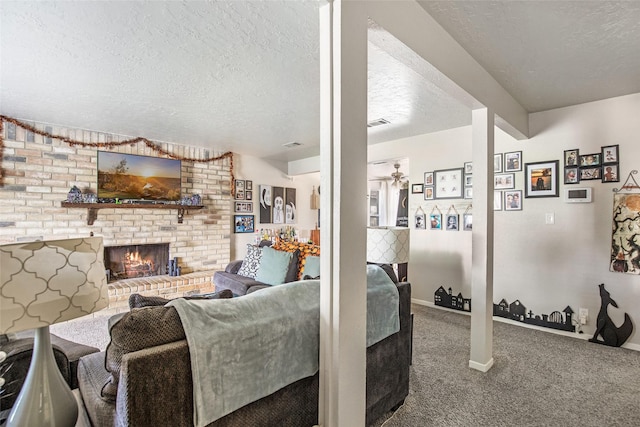 living room with carpet flooring, a textured ceiling, a brick fireplace, and ceiling fan