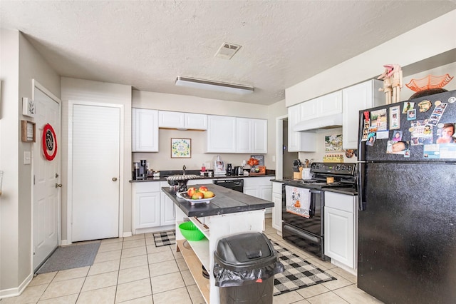 kitchen with white cabinets, light tile patterned floors, and black appliances