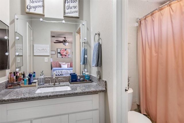 bathroom featuring ceiling fan, toilet, and vanity