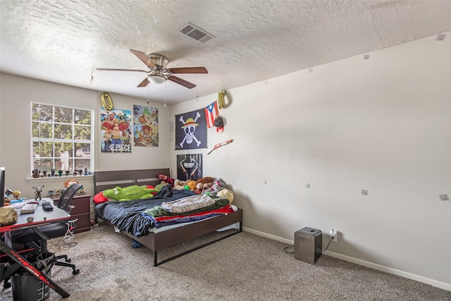 bedroom featuring a textured ceiling, carpet floors, and ceiling fan