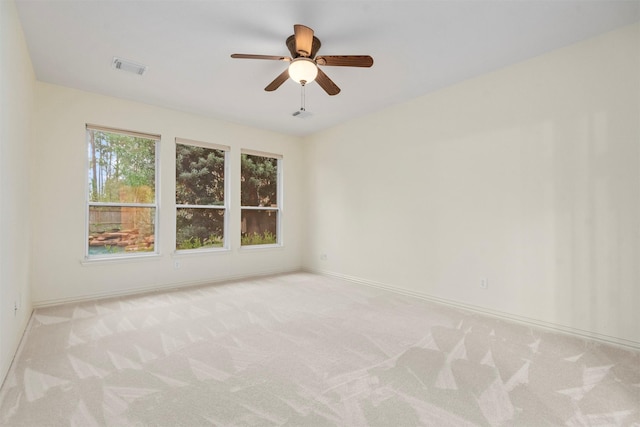 carpeted empty room featuring ceiling fan