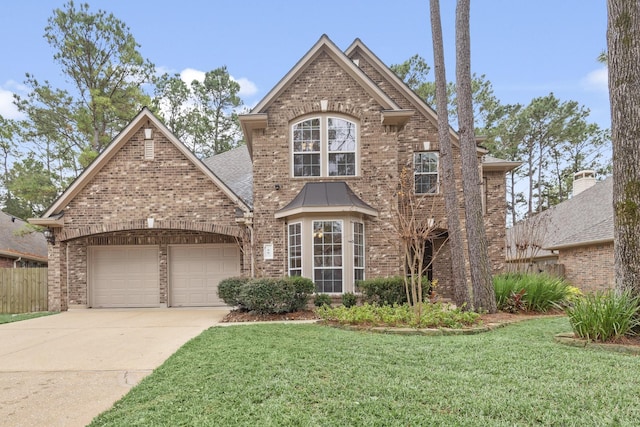 view of property featuring a front yard and a garage