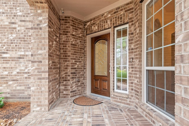 view of exterior entry featuring a porch