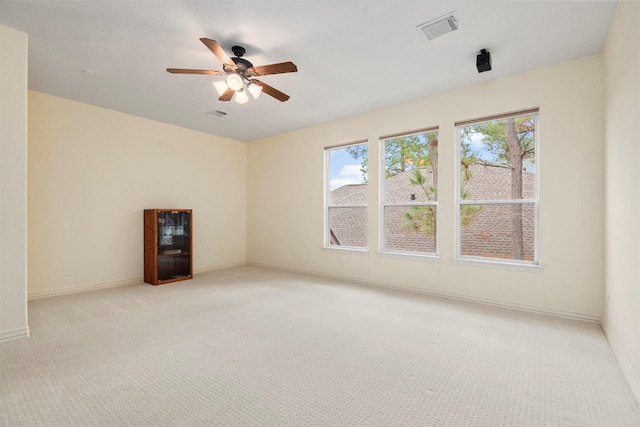 empty room featuring light carpet and ceiling fan