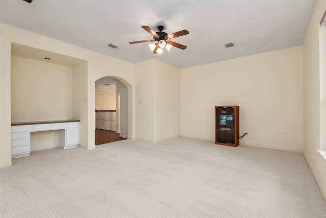 carpeted spare room featuring ceiling fan