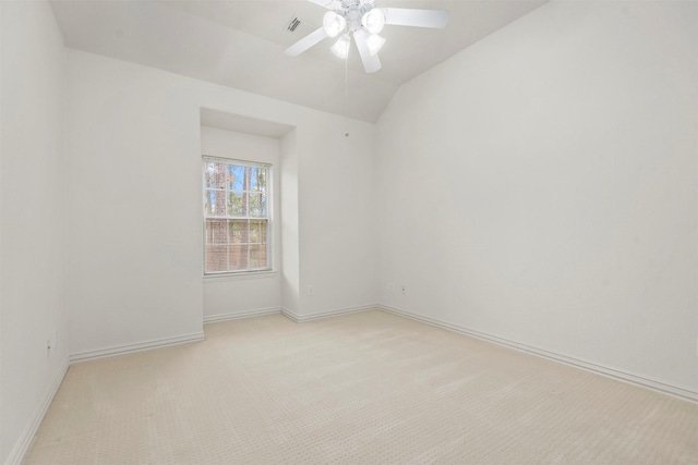 carpeted spare room with ceiling fan and lofted ceiling