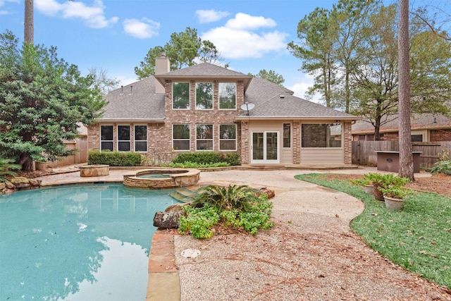 view of pool featuring an in ground hot tub