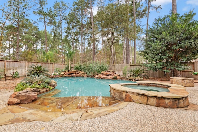 view of swimming pool featuring an in ground hot tub