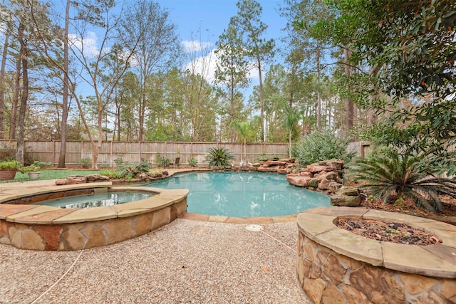 view of pool featuring an in ground hot tub