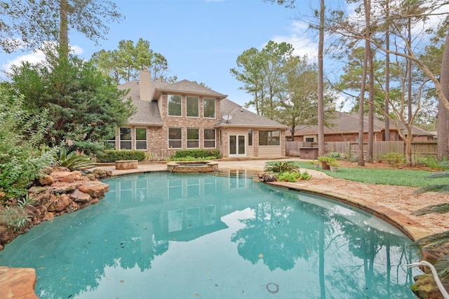 view of swimming pool with an in ground hot tub