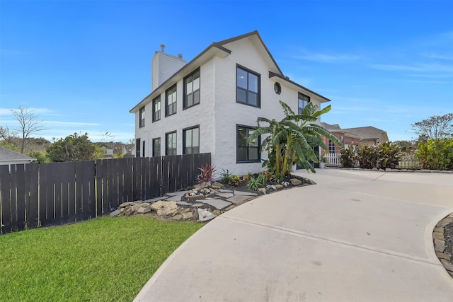 view of side of home with a lawn