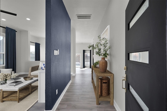 corridor with hardwood / wood-style flooring