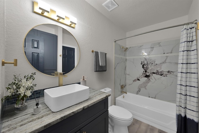 full bathroom featuring shower / bath combo, vanity, a textured ceiling, hardwood / wood-style floors, and toilet