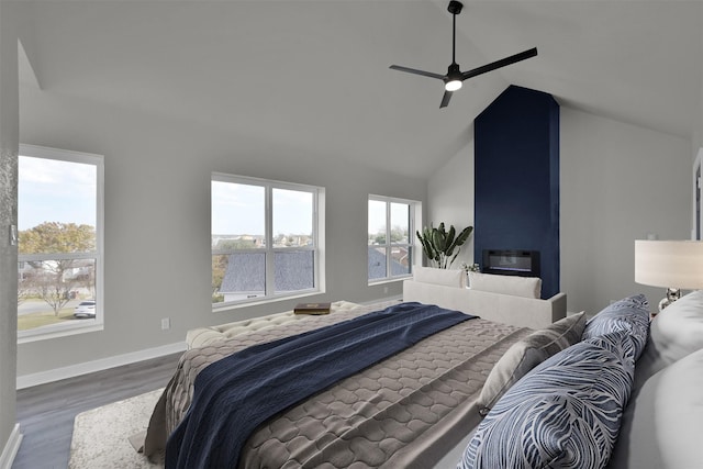 bedroom with a fireplace, dark hardwood / wood-style flooring, high vaulted ceiling, and ceiling fan