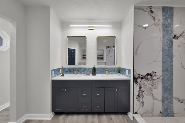 bathroom with vanity, a textured ceiling, and hardwood / wood-style flooring