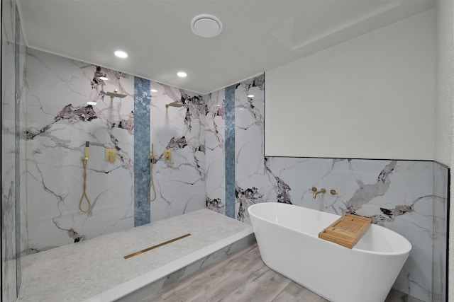 bathroom featuring hardwood / wood-style floors, tile walls, and independent shower and bath