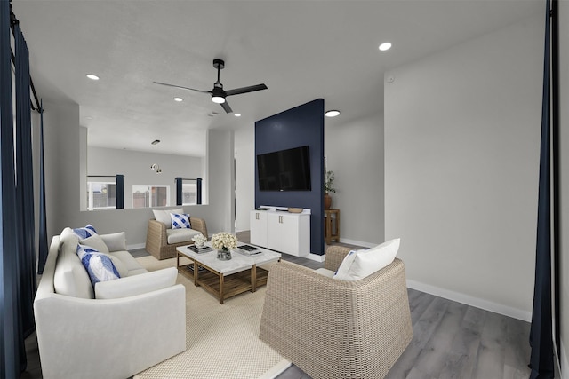 living room with hardwood / wood-style flooring and ceiling fan