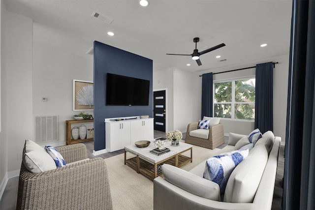 living room with ceiling fan and light wood-type flooring