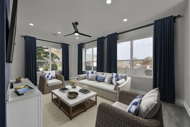 living room with ceiling fan and light hardwood / wood-style flooring