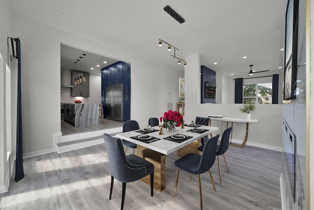 dining room with ceiling fan and light hardwood / wood-style floors