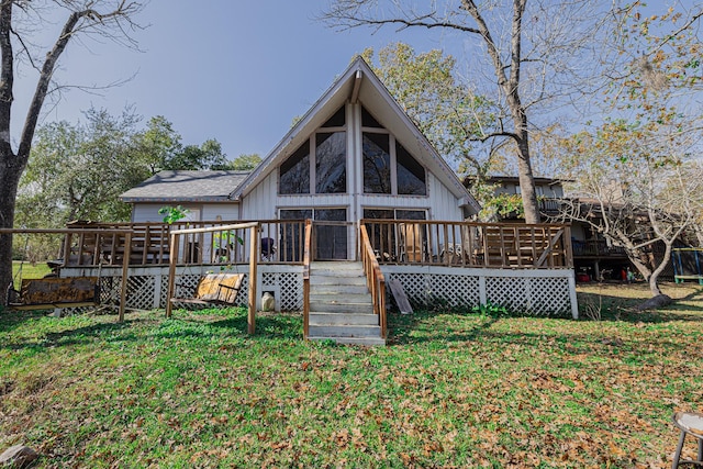 back of house featuring a deck and a yard