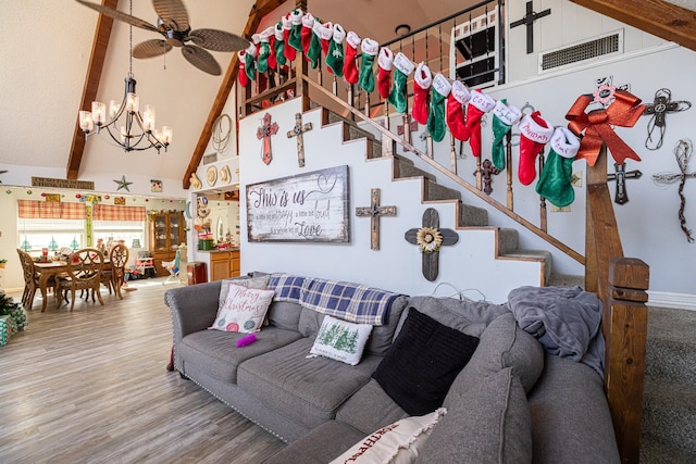 living room featuring hardwood / wood-style floors, ceiling fan with notable chandelier, high vaulted ceiling, and beam ceiling